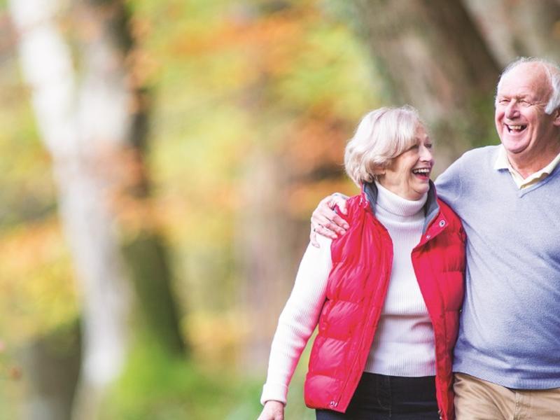 Older couple walking in woods