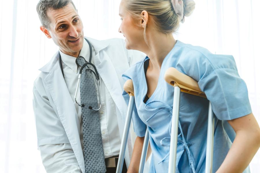 Doctor with Patient on crutches