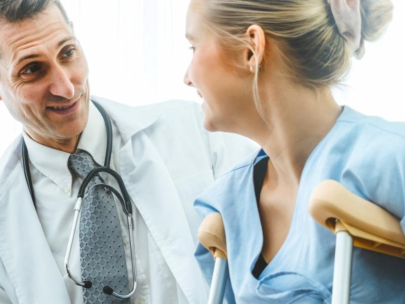 Doctor with Patient on crutches