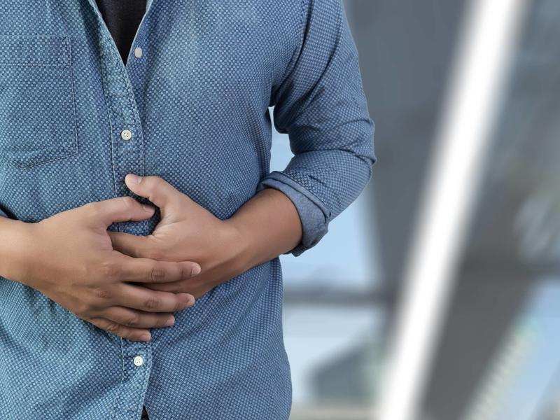 woman holding her stomach in pain