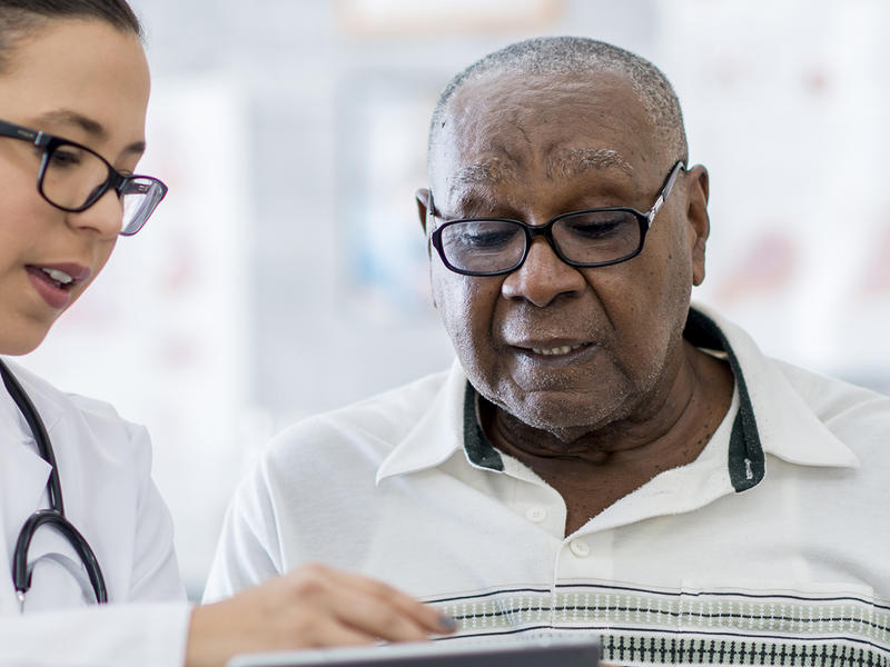 Doctor educating geriatric patient