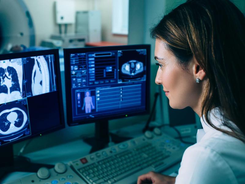 Healthcare worker viewing xrays on computer