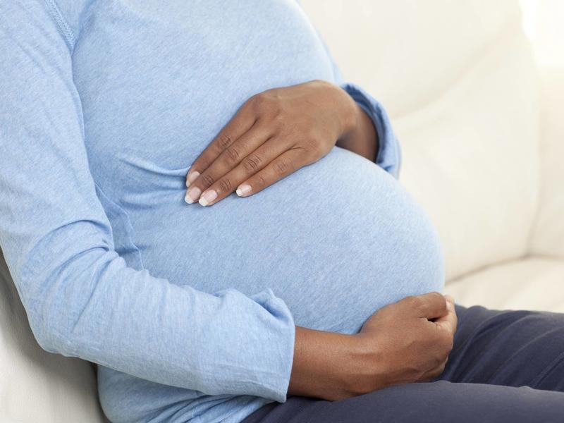 woman holding her pregnant belly