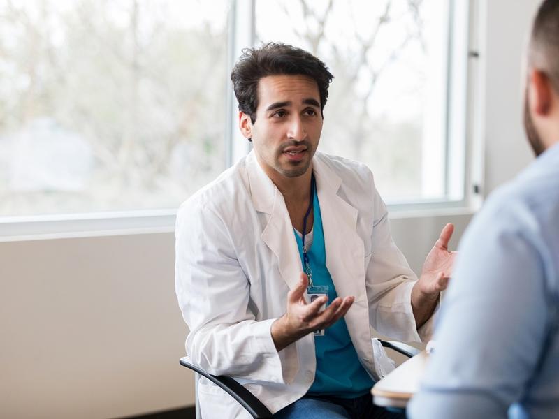 Male doctor in a conversation with male patient.